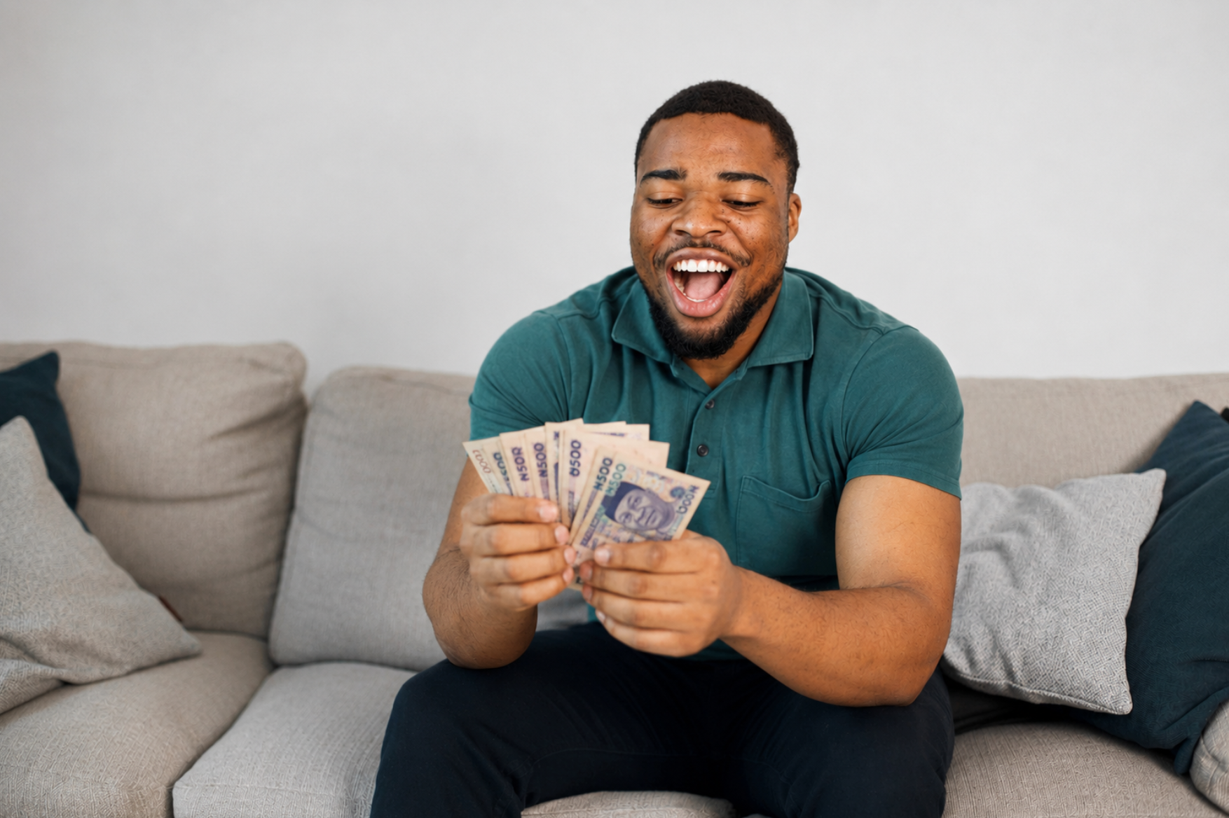 Small business owner smiling while counting cash from a loan disbursement